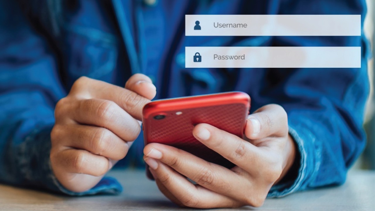 Man holding phone; image used for the HSBC Sri Lanka Safe and Secure Page