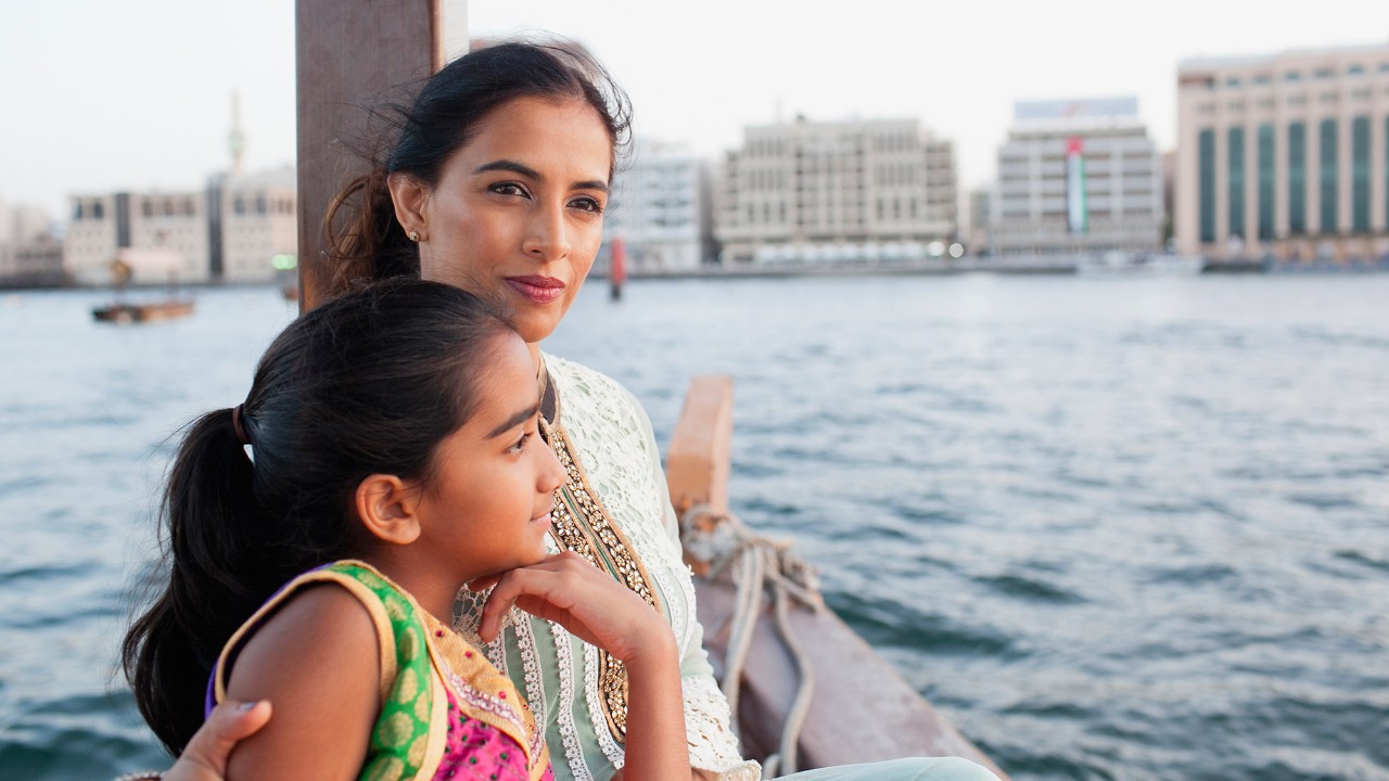 Mother and daughter are enjoying the river view; image used for "spend wisely" article.