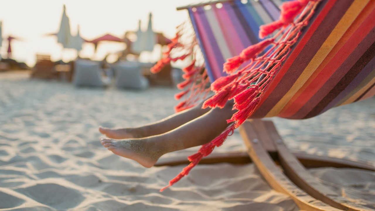 pair of legs on hammock at beach; image used for HSBC Sri Lanka Visa Gold Credit Card