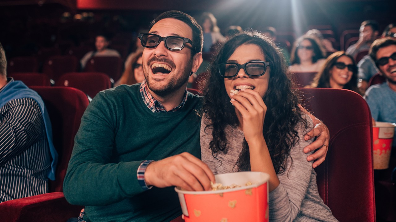 a couple watching movie and eating popcorn; image used for HSBC Sri Lanka entertainment merchant partner's page.