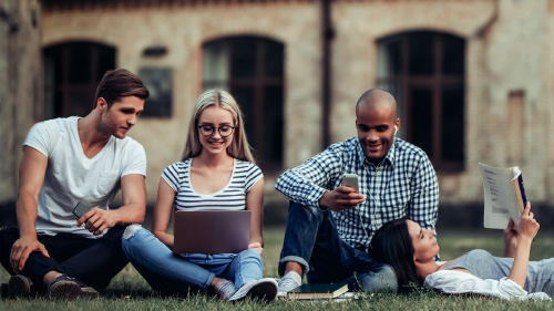 Four students studying on the grass; image used for HSBC Sri Lanka International Services Overseas Education page