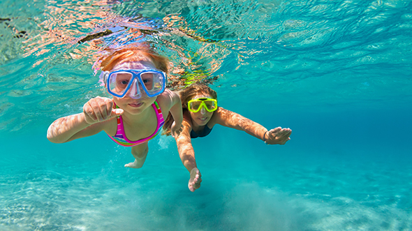 two little girls are swimming in the pool; image used for HSBC Sri Lanka Local Holidays Merchant Partners Landing Page