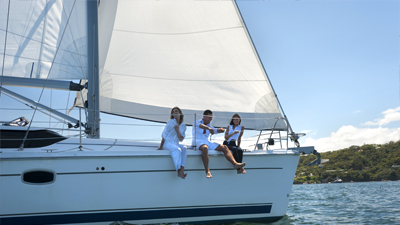 Three people on sailing boat happily; image used for HSBC Sri Lanka Homepage