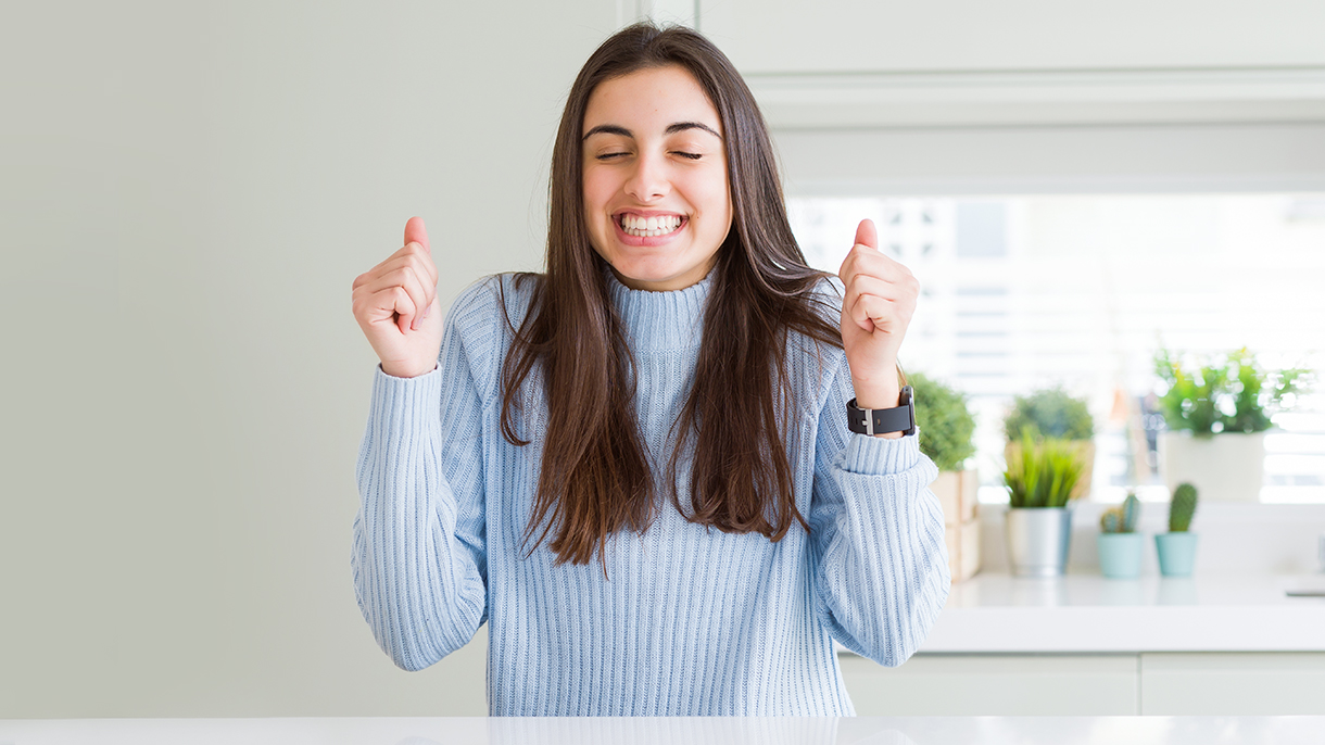 a young woman acting thrilled