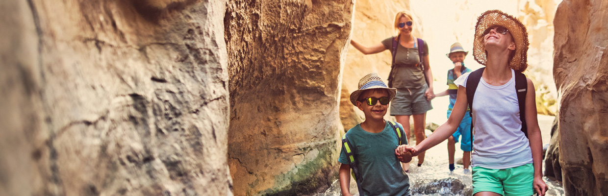 Parents talking their daughter playing by the sea; image used for HSBC Advance page.