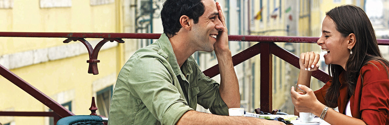 a young couple chatting happily in a cafe's balcony seats; image used for HSBC LK Preferential rates and rewards page.