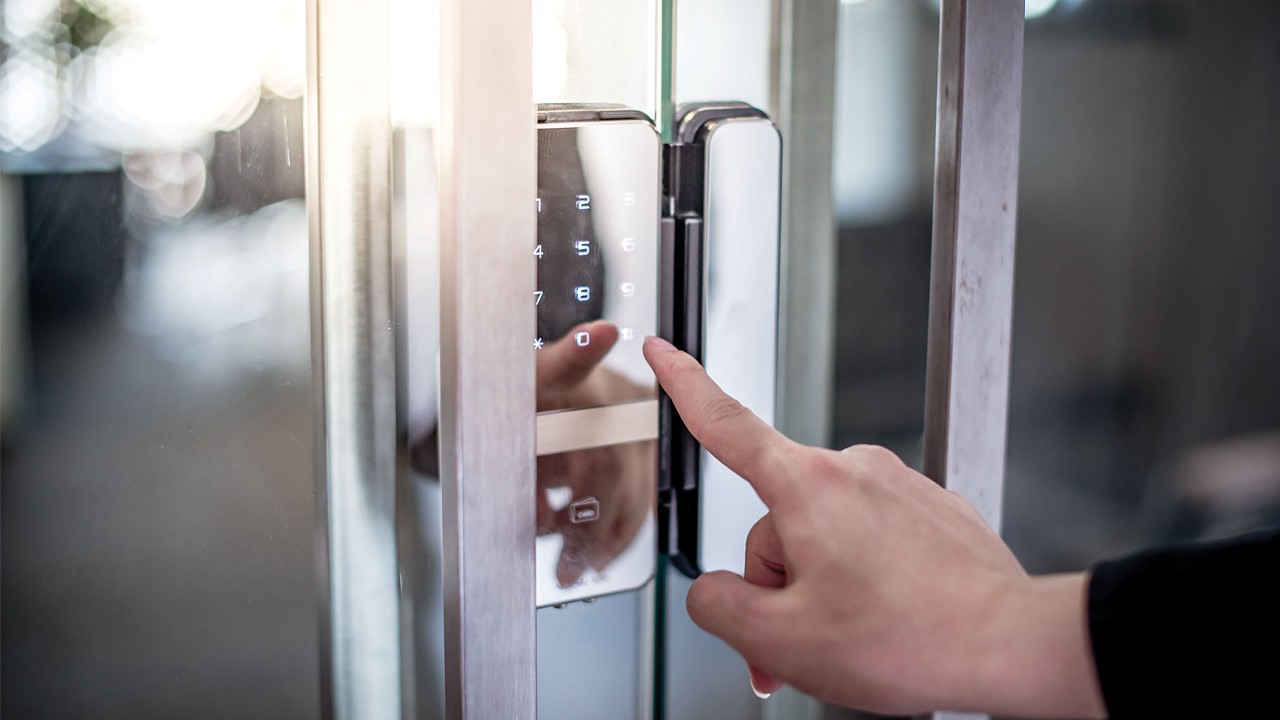 fingers going to touch an electronic locks on a door; image used for HSBC LK secure password page