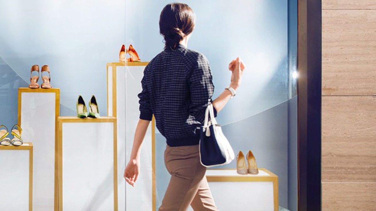 A window shopping woman is looking at shoes display; image used for HSBC Premier Credit Card Landing Page